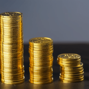 Up of a stack of golden Canadian coins with an Ethereum logo on each one, with a few coins highlighted in a brighter gold