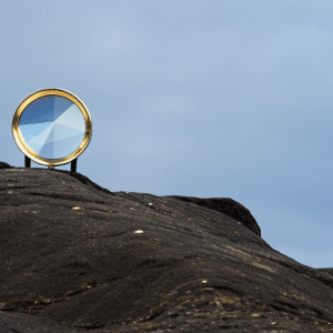 Graph showing the historical price of Ethereum with a magnifying glass hovering over it, emphasizing the importance of studying the past for forecasting the future